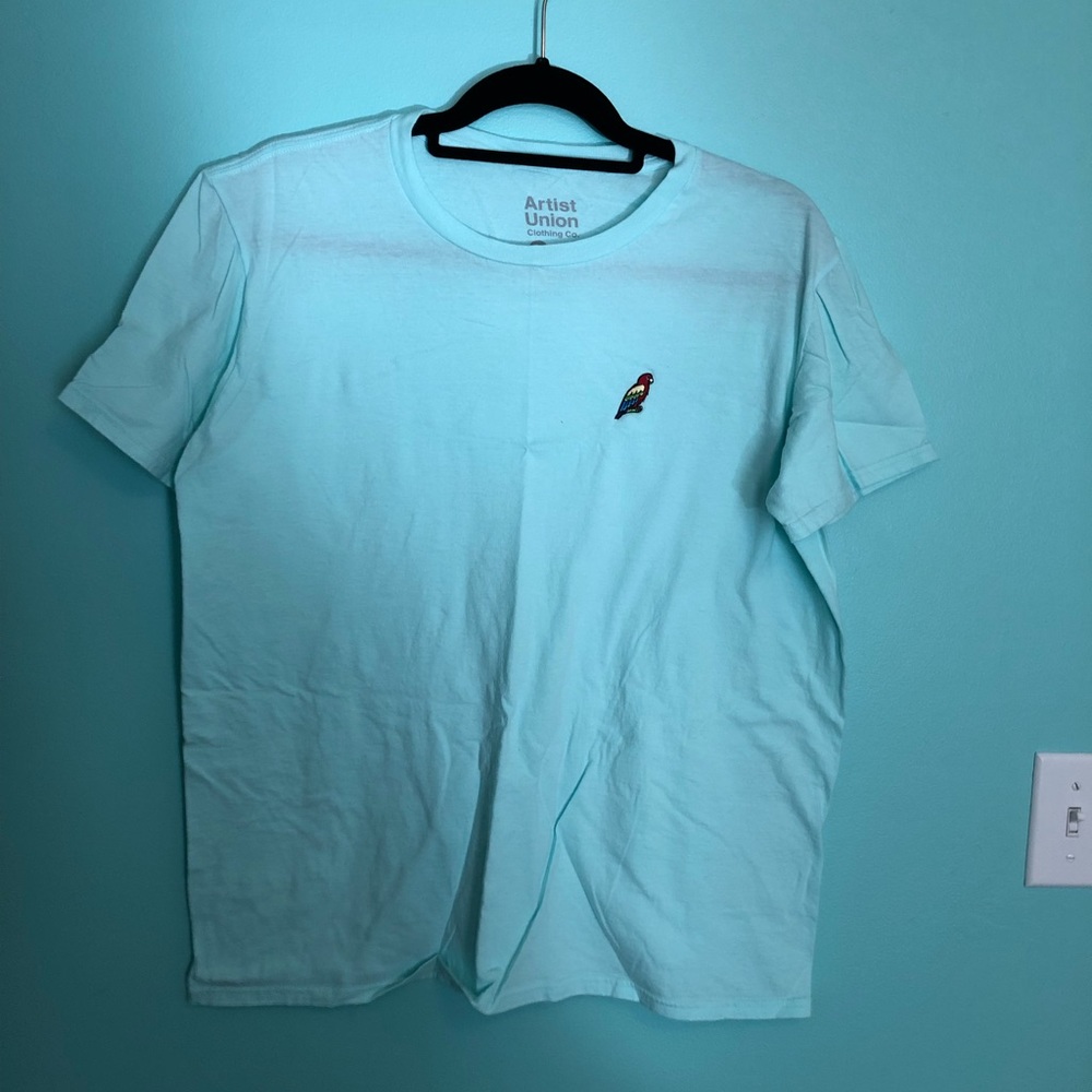 Light blue shirt with parrot on the front